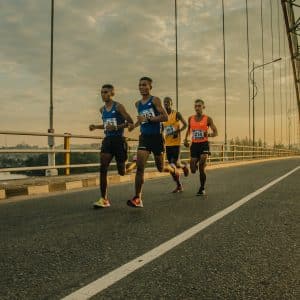 four men running on asphalt floor